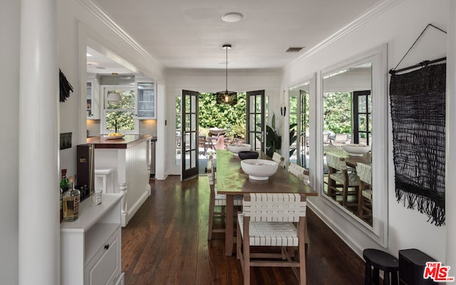 dining space featuring crown molding, french doors, and dark wood-type flooring