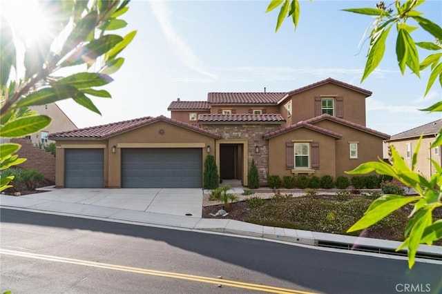 mediterranean / spanish-style home with a garage