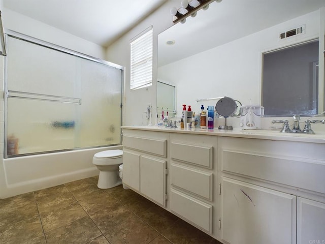 full bathroom featuring shower / bath combination with glass door, vanity, and toilet