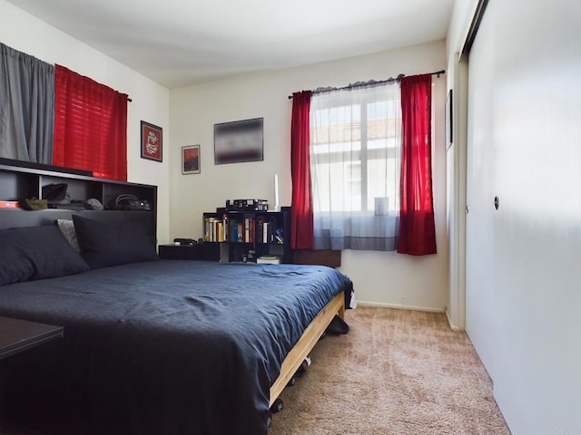 bedroom featuring light carpet