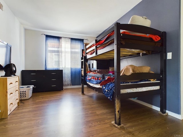 bedroom with dark wood-type flooring