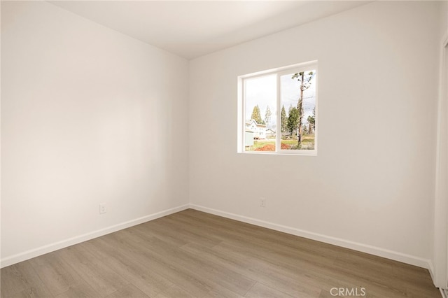 unfurnished room featuring hardwood / wood-style flooring