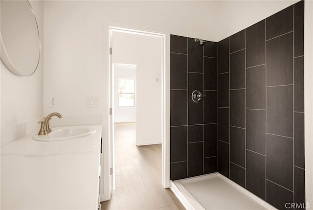 bathroom featuring vanity and a tile shower