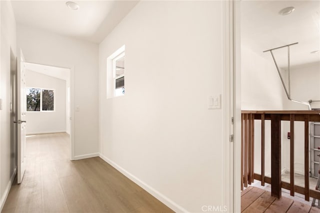 corridor with light hardwood / wood-style floors