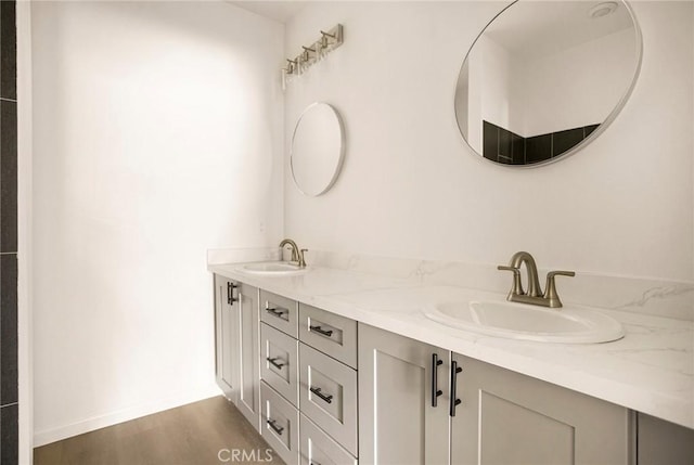 13990 Pineland Cir, Magalia, CA 95954 - bathroom featuring double vanity, wood finished floors, and baseboards
