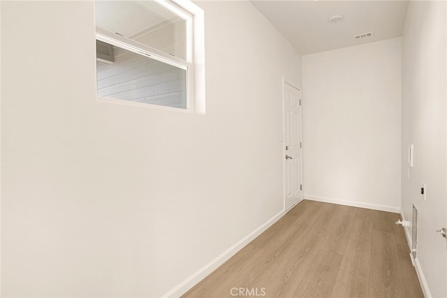 corridor with light wood-type flooring