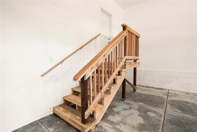 stairs featuring concrete floors