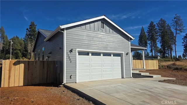13990 Pineland Cir, Magalia, CA 95954 - view of side of property featuring board and batten siding, concrete driveway, and a garage