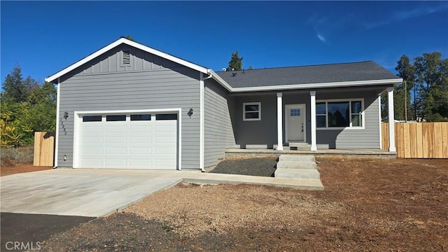 13990 Pineland Cir, Magalia, CA 95954 - ranch-style home with covered porch, concrete driveway, an attached garage, and board and batten siding
