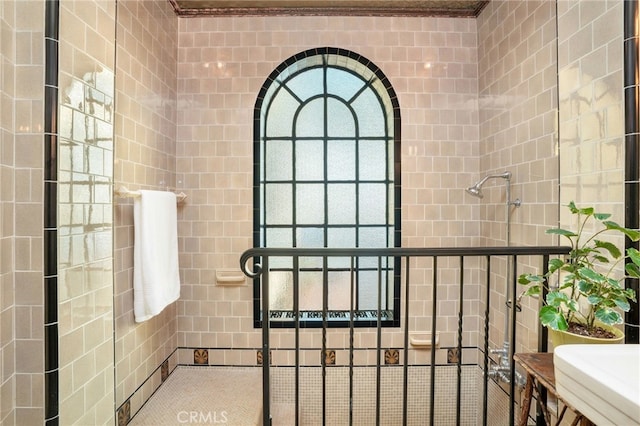 bathroom with tile walls and ornamental molding