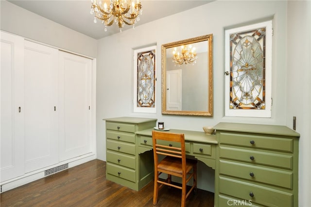 home office with built in desk, dark wood-type flooring, and a chandelier