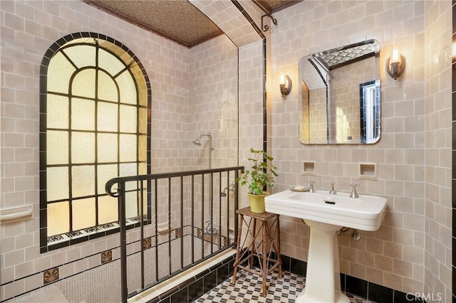 bathroom featuring crown molding, tile patterned floors, and tile walls