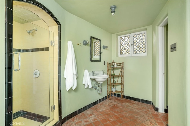 bathroom with a shower with door