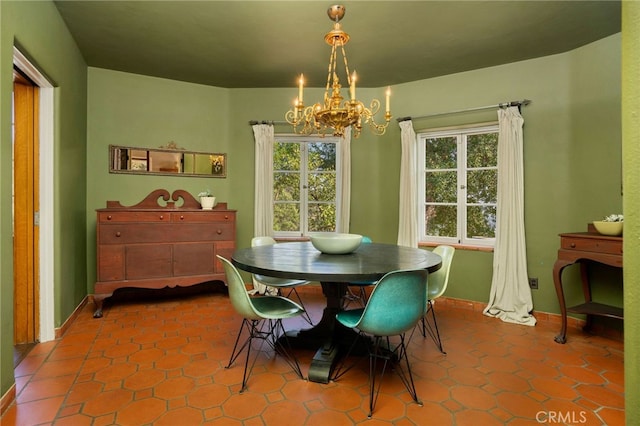 dining space featuring a notable chandelier, plenty of natural light, and tile patterned flooring