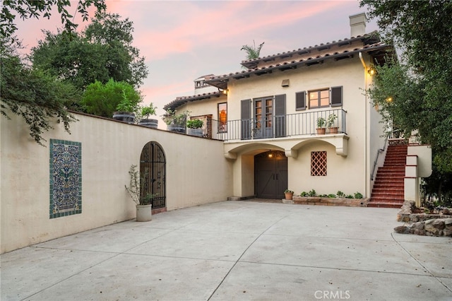 mediterranean / spanish-style home featuring a balcony