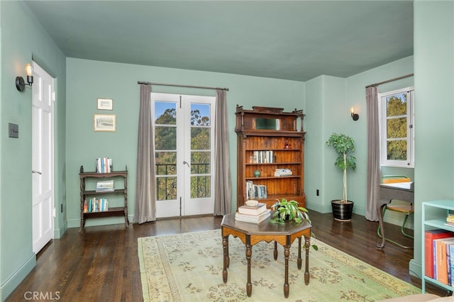 sitting room with french doors and dark wood-type flooring