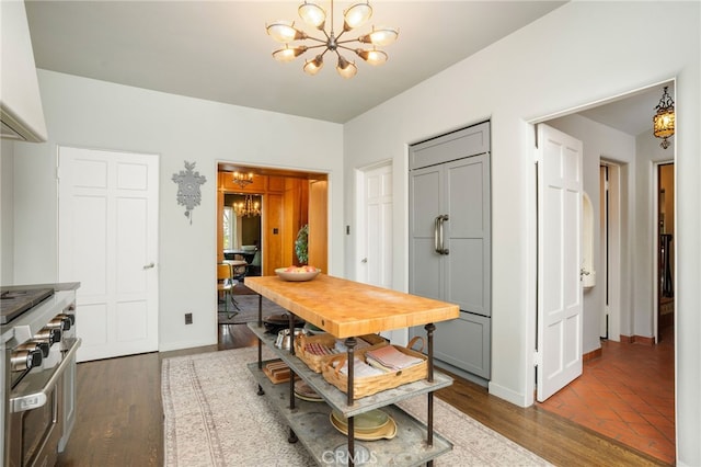 dining area featuring a notable chandelier and dark wood-type flooring