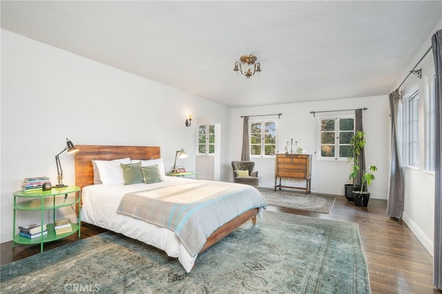 bedroom with dark hardwood / wood-style flooring