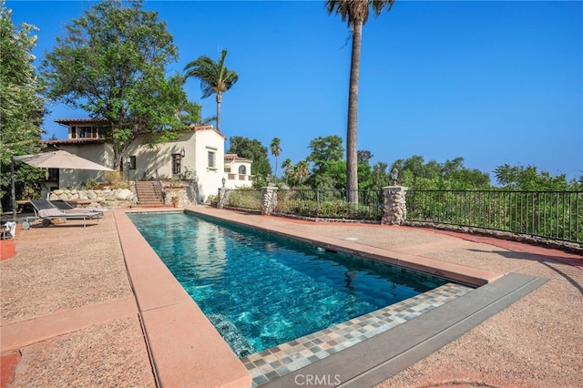 view of swimming pool featuring a patio area