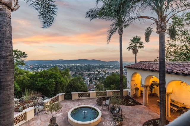 exterior space with a hot tub and a mountain view