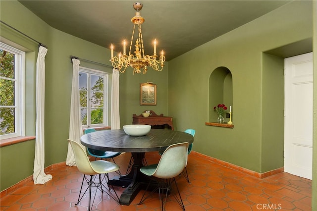 dining space featuring a chandelier and tile patterned flooring