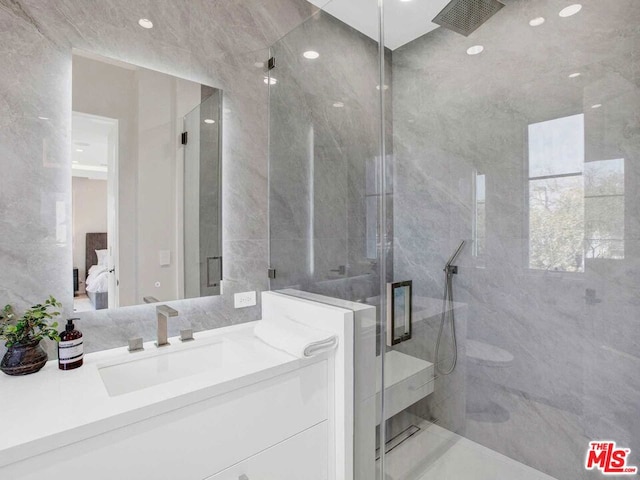 bathroom with vanity and a shower with door