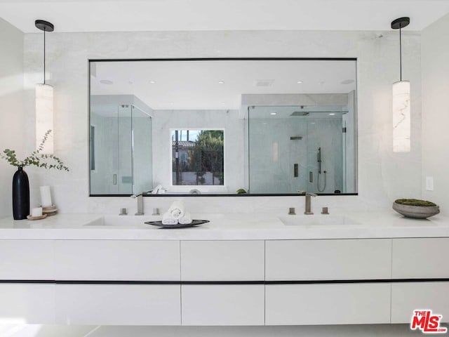 bathroom featuring vanity and a shower with shower door