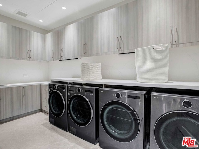 washroom featuring washer and dryer and light tile patterned floors