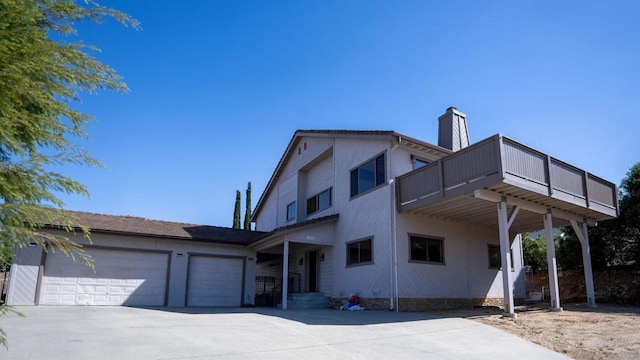 view of front of house featuring a garage and a balcony