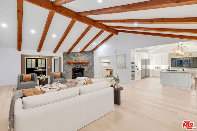 living room with high vaulted ceiling, light hardwood / wood-style flooring, a notable chandelier, beamed ceiling, and a stone fireplace