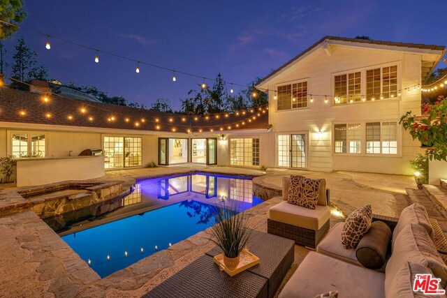 view of swimming pool with an in ground hot tub, an outdoor living space, a patio, and area for grilling