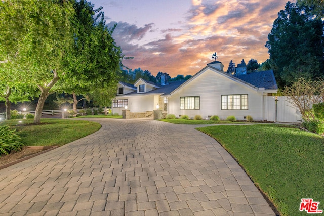 view of front of property with a lawn