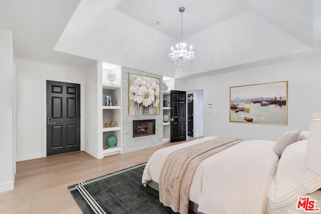 bedroom featuring light hardwood / wood-style floors and an inviting chandelier