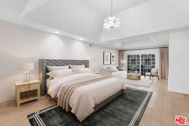 bedroom featuring a notable chandelier and light wood-type flooring