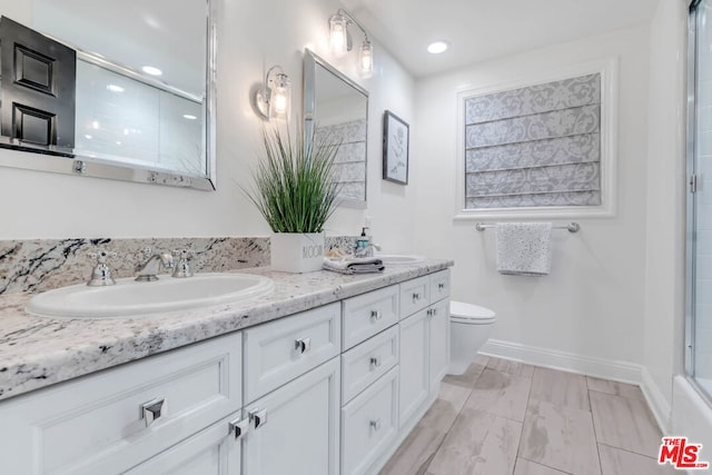 bathroom with vanity, toilet, and an enclosed shower