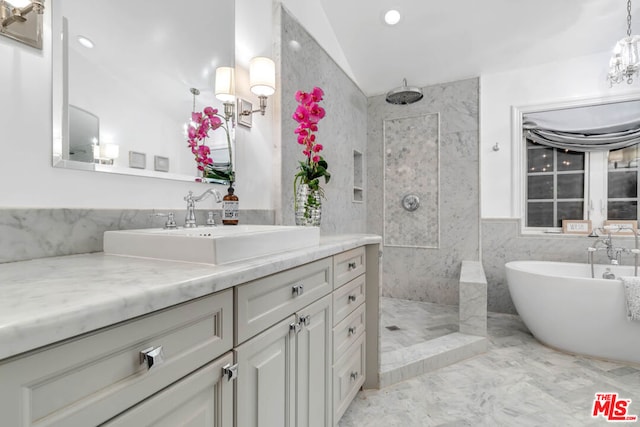 bathroom featuring vanity, vaulted ceiling, and shower with separate bathtub