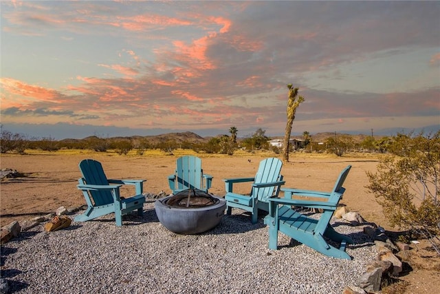 playground at dusk with an outdoor fire pit