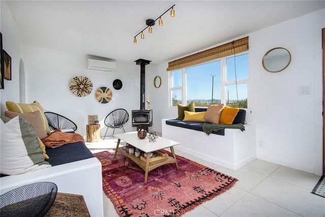 tiled living room featuring a wood stove and an AC wall unit