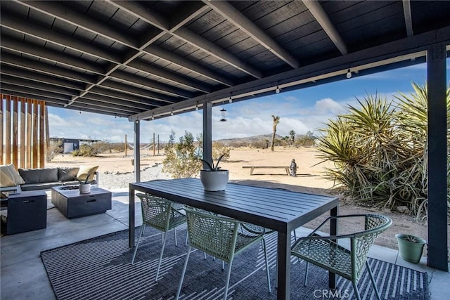 view of patio / terrace with an outdoor living space with a fire pit