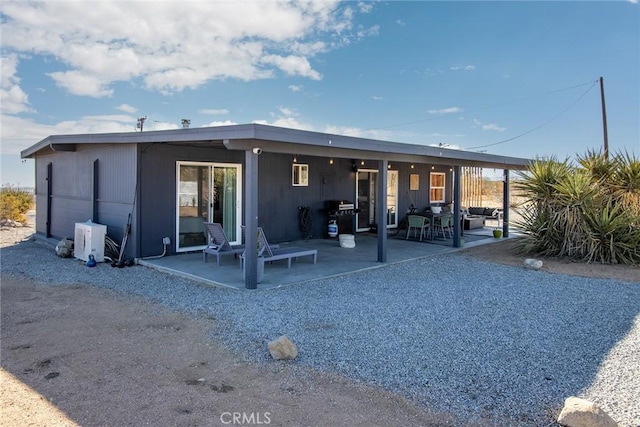 back of house with ac unit and a patio