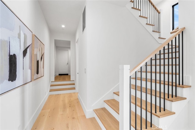 stairway with hardwood / wood-style flooring