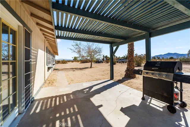 view of patio / terrace with a mountain view and a grill