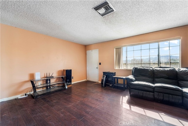 living room with a textured ceiling and hardwood / wood-style flooring