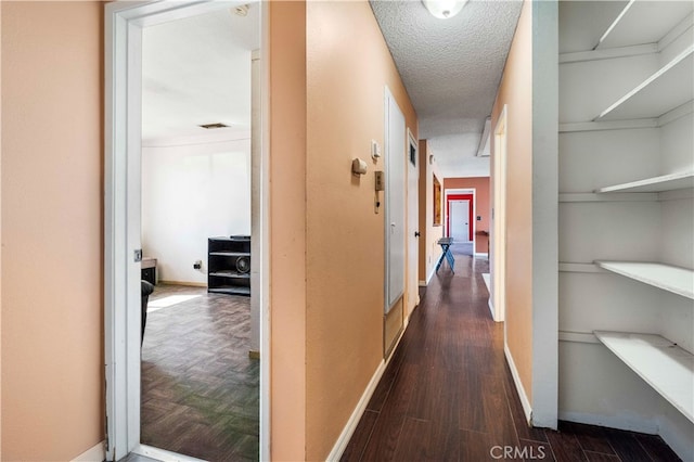 hallway featuring a textured ceiling