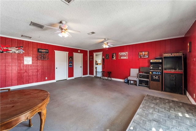 living room with ceiling fan and a textured ceiling