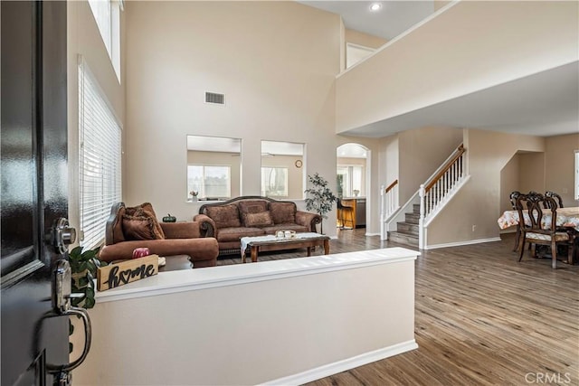 26527 Cardinal Dr, Canyon Country, CA 91387 - living area featuring stairway, wood finished floors, arched walkways, a high ceiling, and recessed lighting