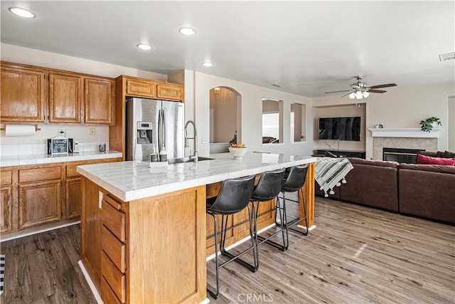 26527 Cardinal Dr, Canyon Country, CA 91387 - kitchen featuring stainless steel fridge with ice dispenser, tile counters, a ceiling fan, arched walkways, and recessed lighting