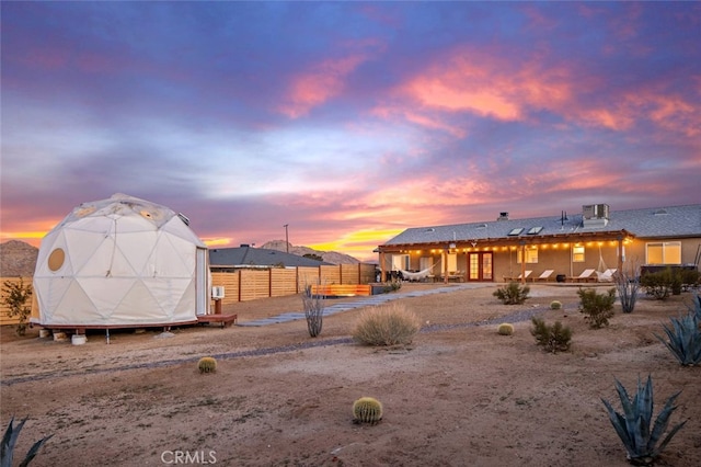 yard at dusk featuring a storage unit