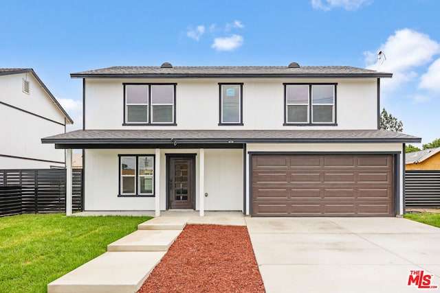 front facade with a front yard and a garage