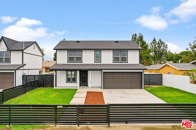 view of front of house with a front lawn and a garage